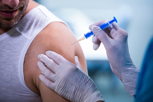 Female doctor giving an injection to a patient