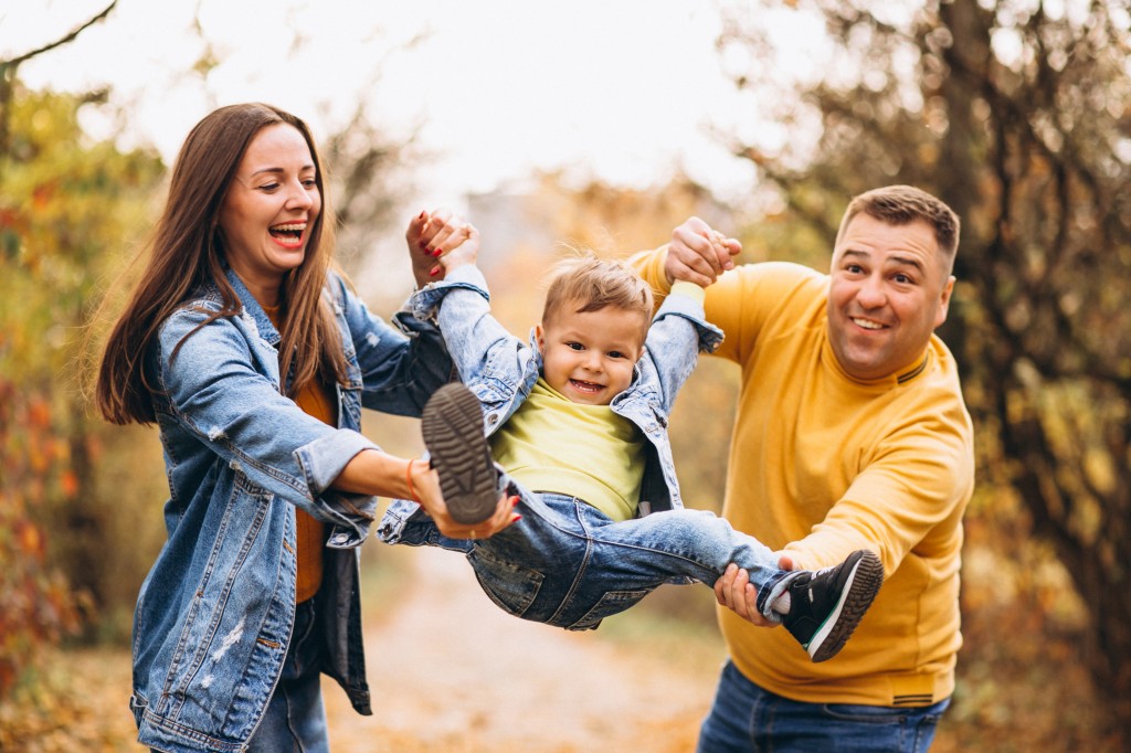 Family with a little son in autumn park